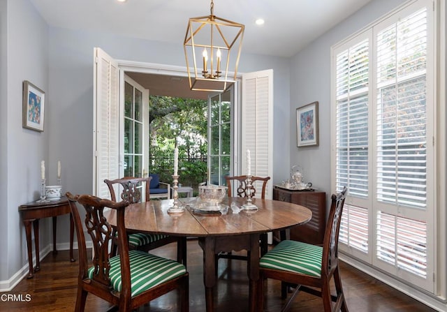 dining space with a chandelier and dark hardwood / wood-style flooring