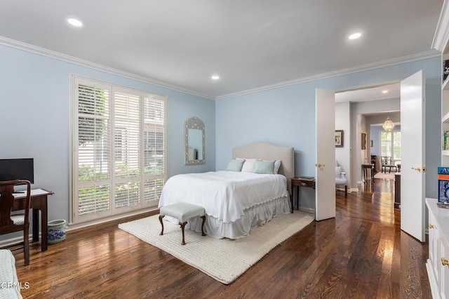 bedroom with dark hardwood / wood-style flooring, an inviting chandelier, multiple windows, and ornamental molding