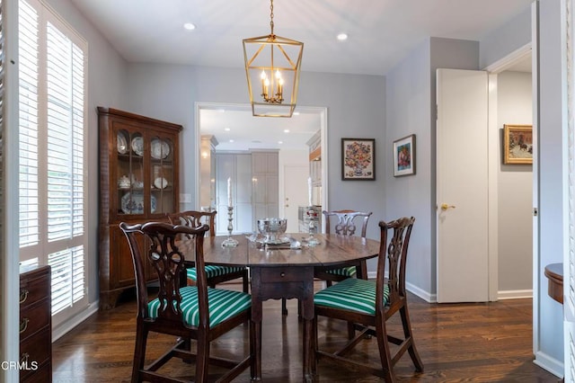 dining space with a chandelier and dark hardwood / wood-style floors