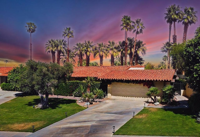 view of front facade featuring a garage and a lawn