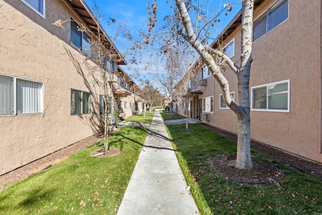 view of property's community with a lawn