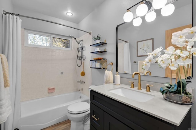 full bathroom featuring shower / bath combo, hardwood / wood-style flooring, toilet, and vanity