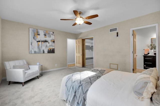 carpeted bedroom with a closet, ceiling fan, and a walk in closet