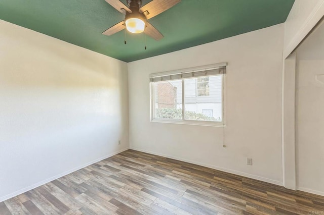 empty room with ceiling fan and wood-type flooring