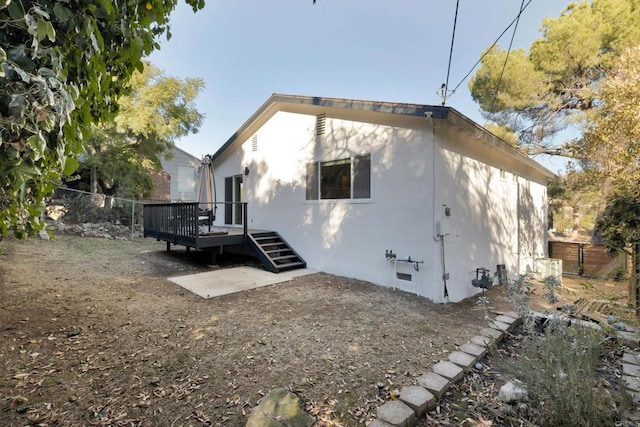 rear view of property with a wooden deck