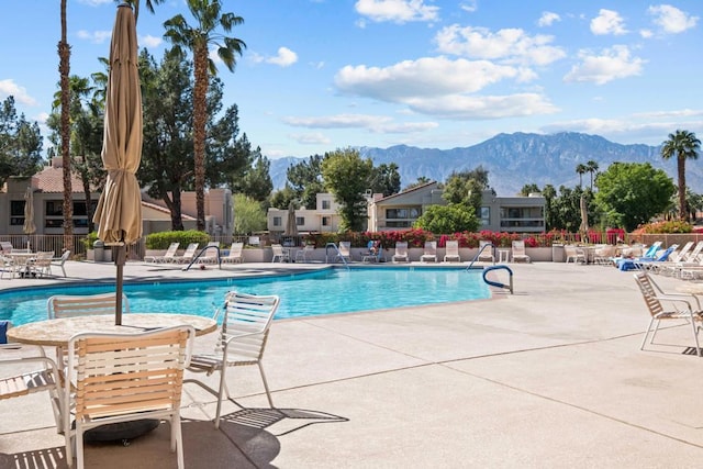 view of pool with a patio area and a mountain view