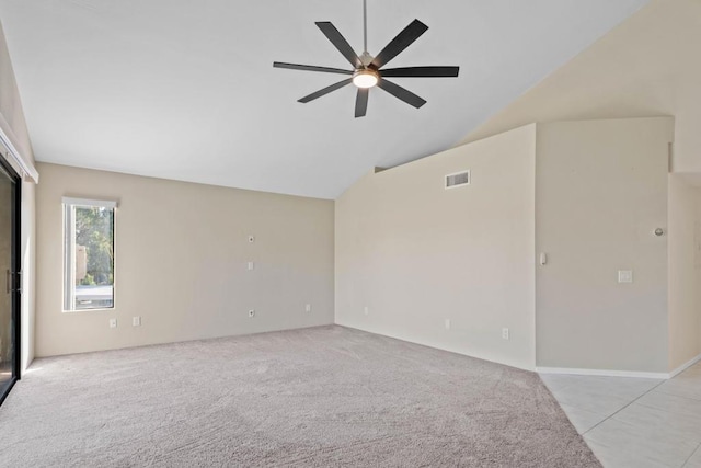 unfurnished room with vaulted ceiling, ceiling fan, and light tile patterned floors