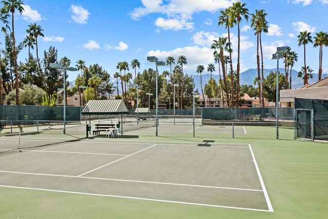 view of tennis court with a mountain view