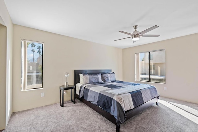 bedroom with ceiling fan and light colored carpet