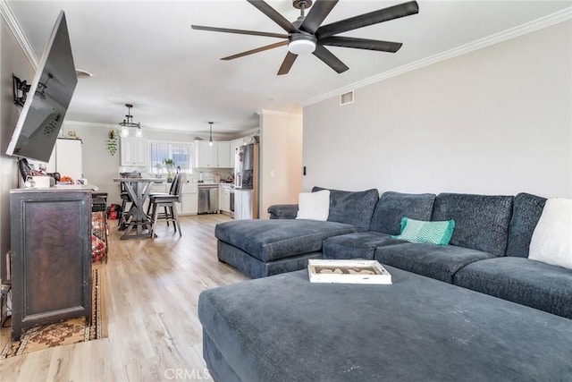 living room with ceiling fan, crown molding, and light hardwood / wood-style flooring