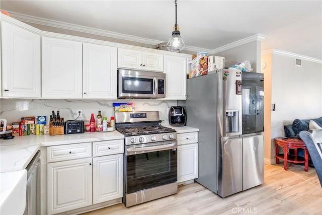 kitchen with stainless steel appliances, white cabinets, and hanging light fixtures