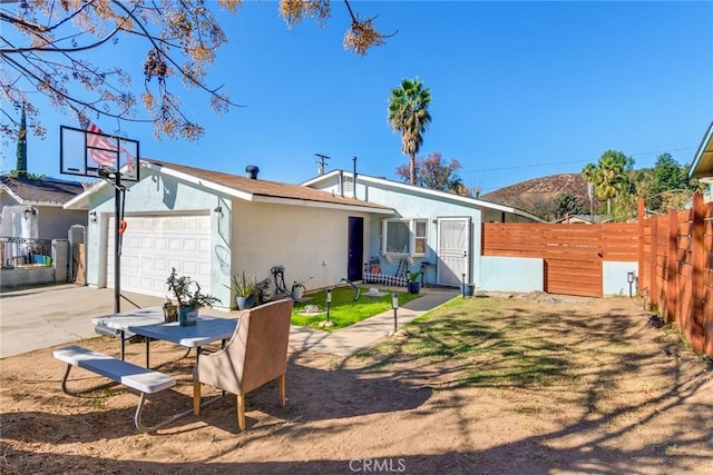 rear view of property with a garage