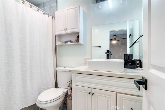 bathroom featuring ceiling fan, vanity, a shower with curtain, and toilet