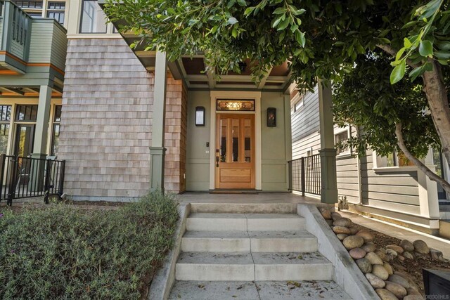 view of exterior entry with covered porch