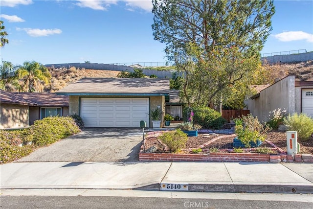 ranch-style home featuring a garage