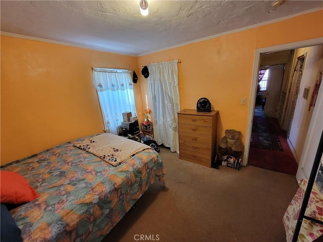 bedroom featuring a textured ceiling, carpet, and ornamental molding