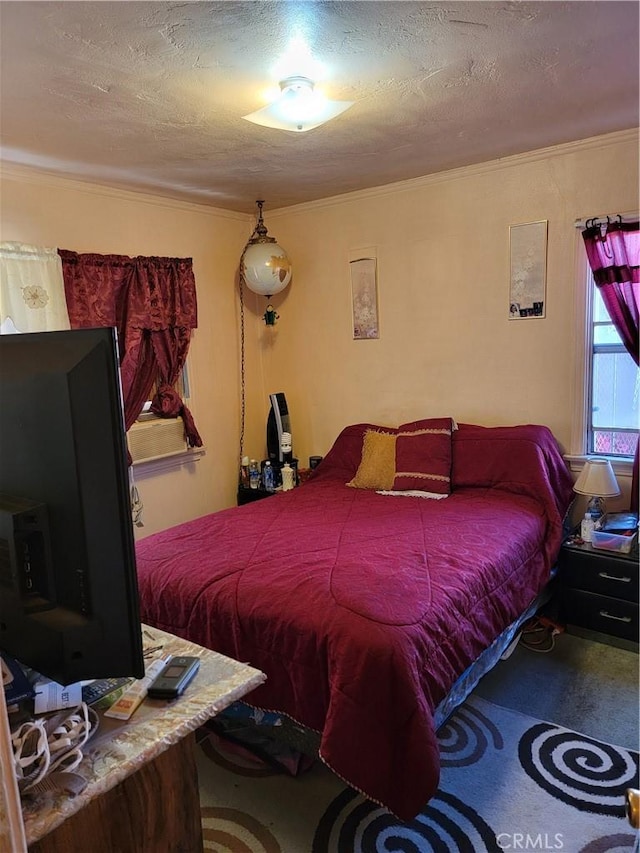 bedroom with carpet flooring and a textured ceiling