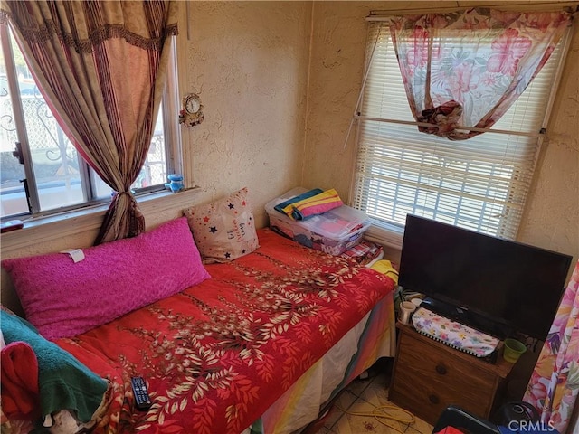 bedroom featuring multiple windows