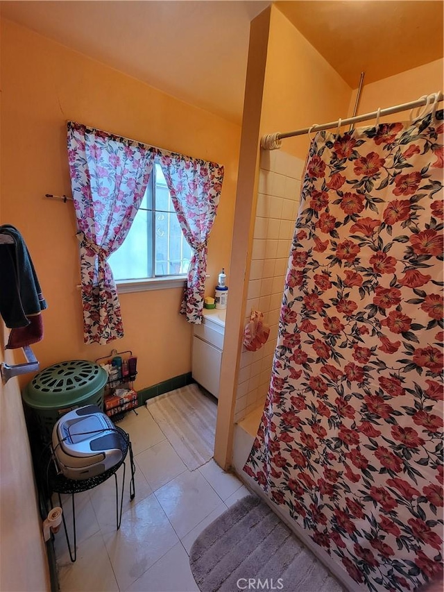 bathroom featuring a shower with curtain and tile patterned flooring