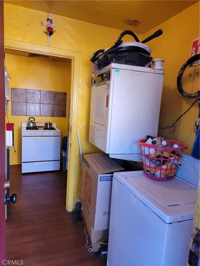 laundry room featuring stacked washer / dryer and dark hardwood / wood-style flooring