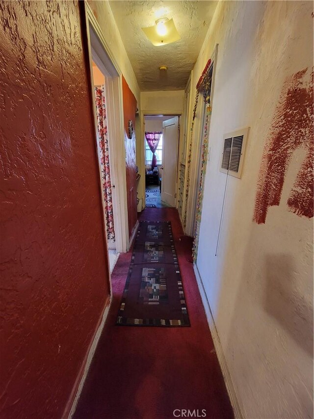 hallway featuring a textured ceiling