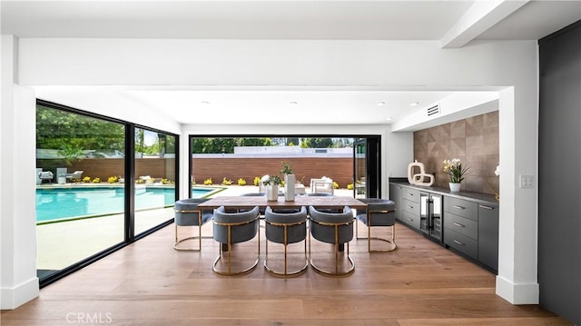 kitchen with a breakfast bar and light wood-type flooring