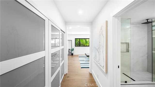 hall with light hardwood / wood-style flooring