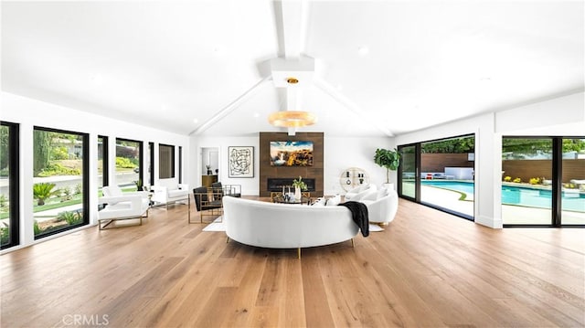 living room with a fireplace, light wood-type flooring, and vaulted ceiling with beams