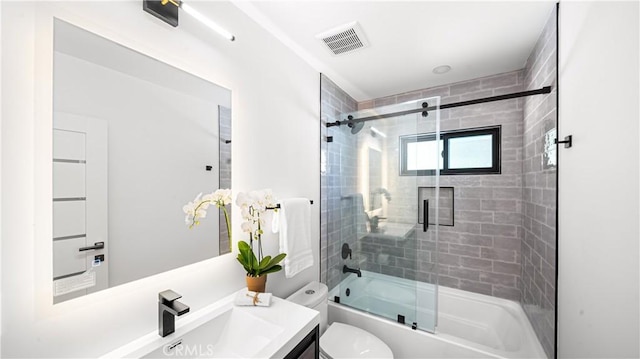 full bathroom featuring combined bath / shower with glass door, vanity, and toilet