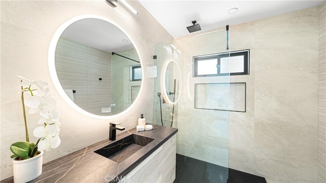 bathroom featuring vanity and tiled shower