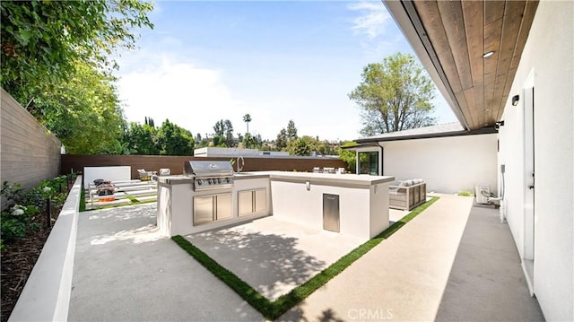 view of patio / terrace featuring area for grilling and exterior kitchen