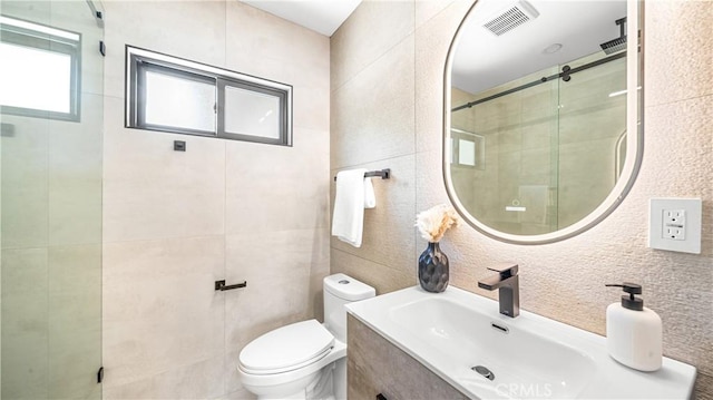 bathroom featuring toilet, vanity, tile walls, tasteful backsplash, and an enclosed shower