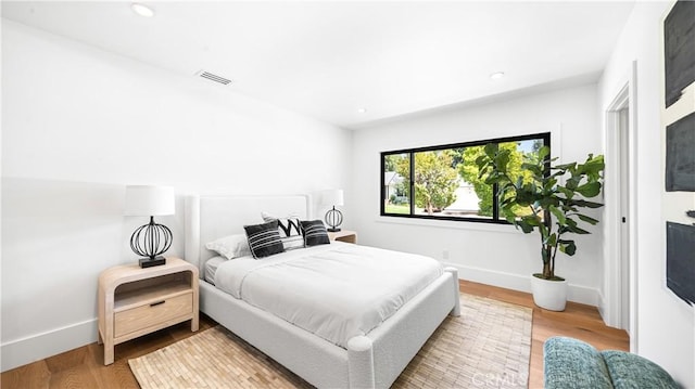 bedroom with hardwood / wood-style flooring