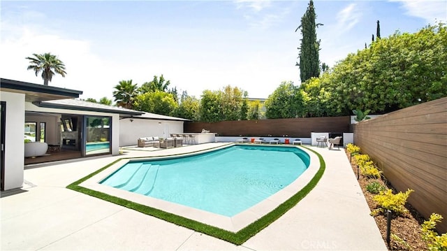 view of swimming pool featuring a patio area