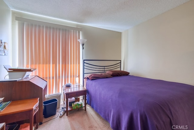 bedroom featuring a textured ceiling and carpet flooring