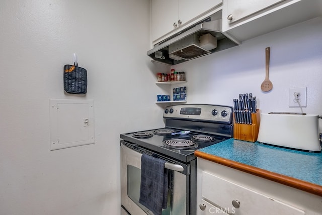 kitchen featuring stainless steel electric stove and white cabinetry