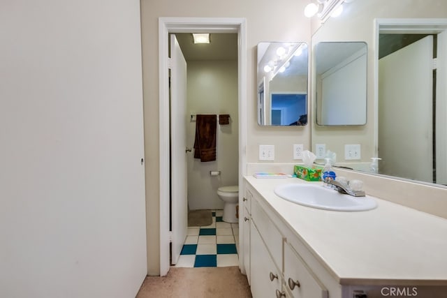 bathroom featuring toilet and vanity