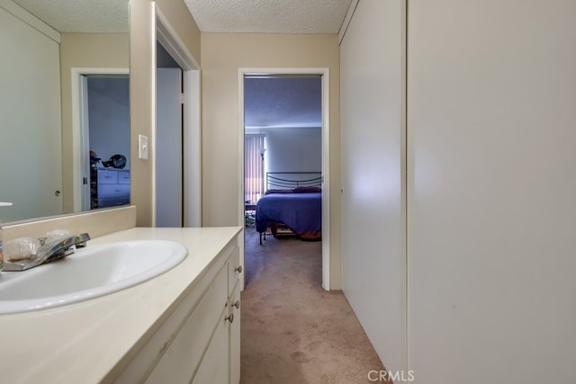 bathroom with a textured ceiling and vanity