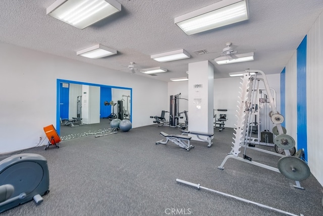 gym with a textured ceiling and ceiling fan