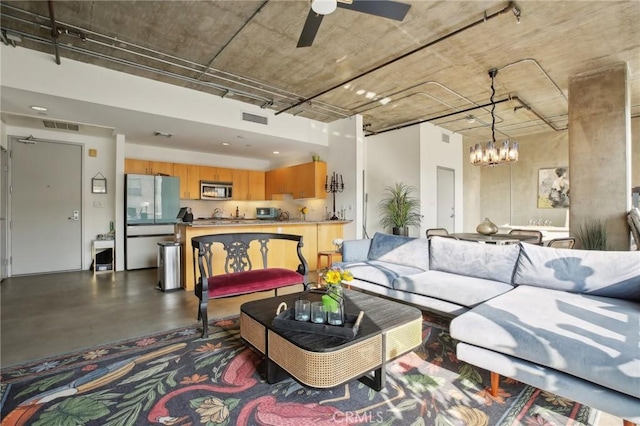 living room with ceiling fan with notable chandelier