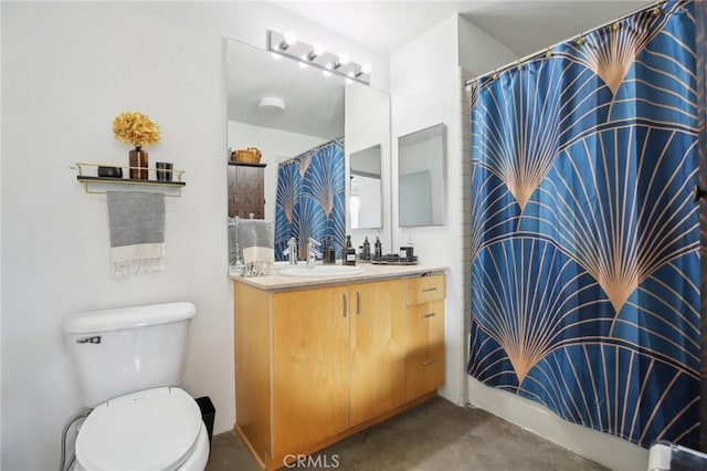 bathroom featuring toilet, concrete flooring, and vanity