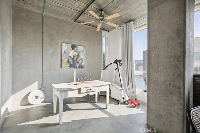 miscellaneous room with ceiling fan and concrete floors