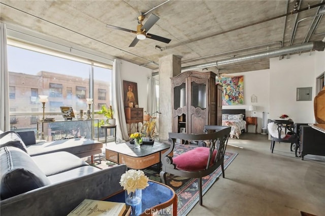 interior space featuring ceiling fan, concrete floors, and electric panel