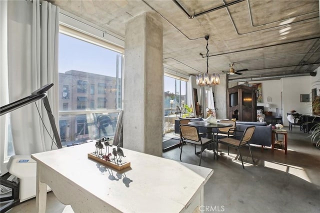 dining area with ceiling fan with notable chandelier