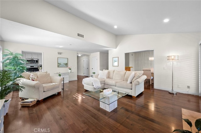 living room with dark hardwood / wood-style floors and lofted ceiling