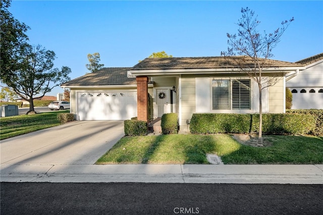 view of front of property featuring a garage and a front lawn