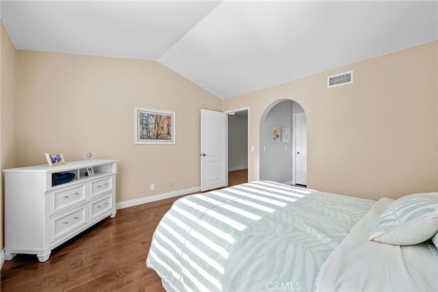 bedroom with lofted ceiling and dark wood-type flooring