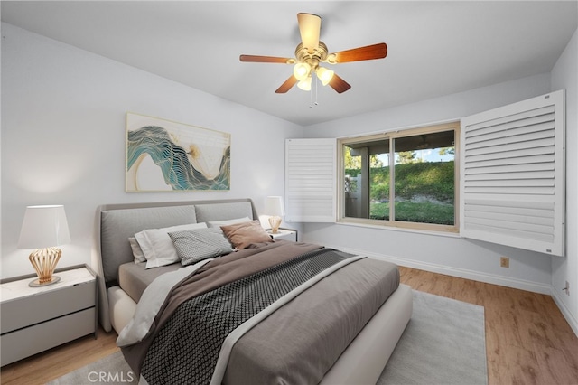 bedroom with ceiling fan and light hardwood / wood-style floors