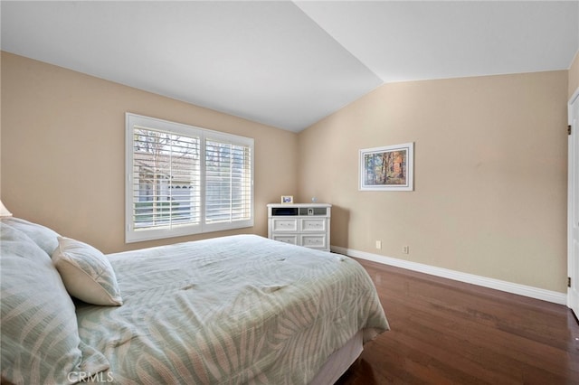 bedroom with dark wood-type flooring and vaulted ceiling