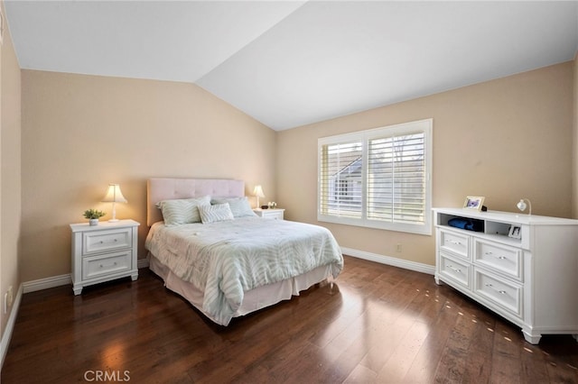 bedroom with dark hardwood / wood-style floors and lofted ceiling